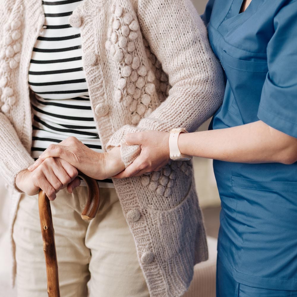 Gentle trained nurse helping mature patient